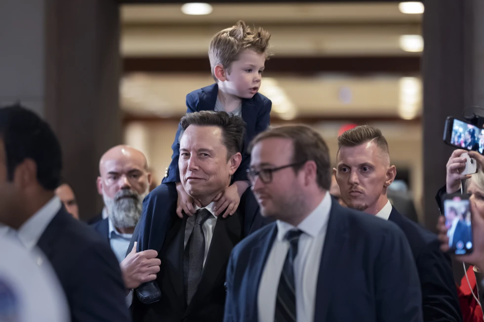 Elon Musk carries his son X Æ A-Xii, after a meeting about President-elect Donald Trump’s planned Department of Government Efficiency, or DOGE, at the Capitol in Washington, Thursday, Dec. 5, 2024. (AP Photo/J. Scott Applewhite)